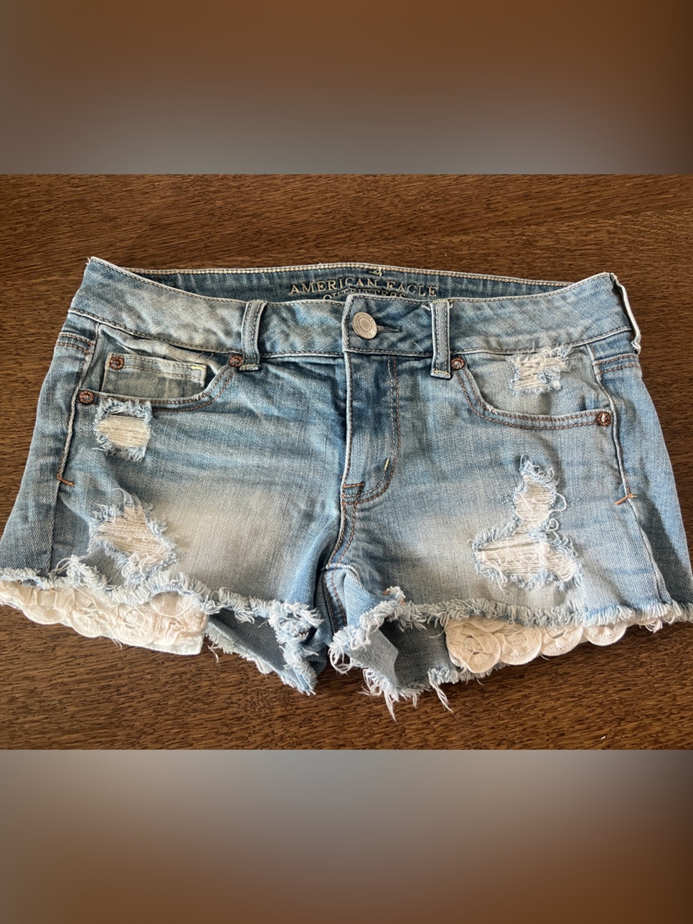 American Eagle Outfitters Light Wash Distressed Denim Shorts with Lace Trim